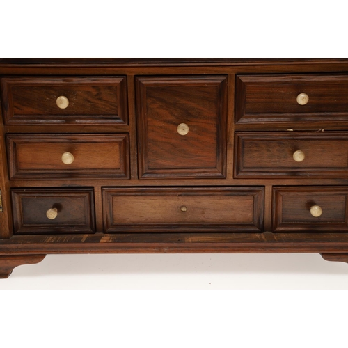 890 - A 19TH CENTURY WALNUT TABLE TOP COLLECTOR'S CABINET. the doors with brass sliding locks enclosing ni... 