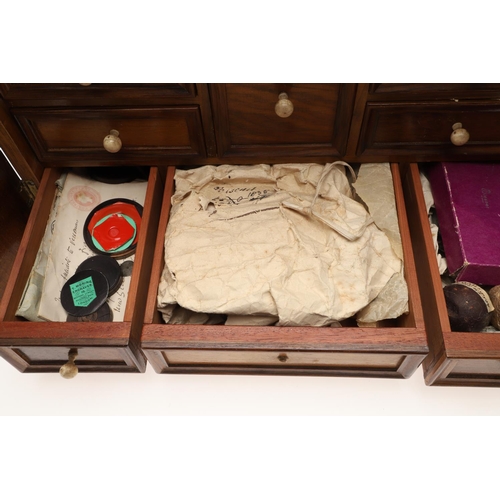 890 - A 19TH CENTURY WALNUT TABLE TOP COLLECTOR'S CABINET. the doors with brass sliding locks enclosing ni... 