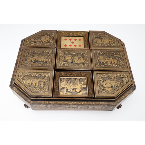 903 - A CHINESE EXPORT LACQUERED GAMES BOX. 19th century, of octagonal form containing seven lidded compar... 