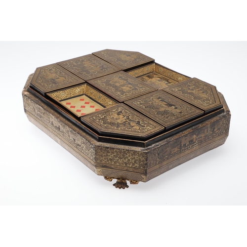 903 - A CHINESE EXPORT LACQUERED GAMES BOX. 19th century, of octagonal form containing seven lidded compar... 