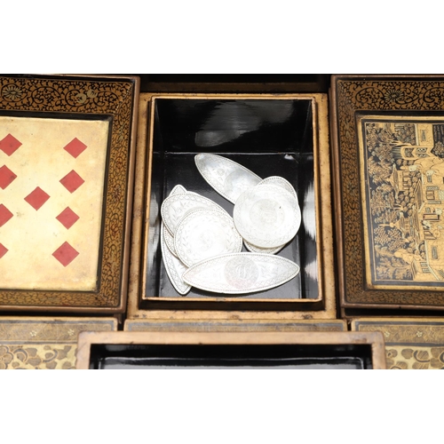 903 - A CHINESE EXPORT LACQUERED GAMES BOX. 19th century, of octagonal form containing seven lidded compar... 