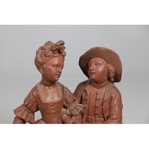 908 - A 19TH CENTURY FRENCH TERRACOTTA GROUP. modelled as a courting couple, seated upon naturalistic base... 