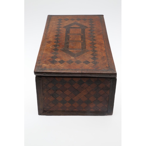 911 - AN ANTIQUE CONTINENTAL PARQUETRY BOX. the hinged lid enclosing a fleur de lys patterned paper lined ... 