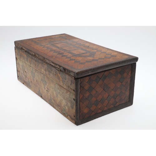 911 - AN ANTIQUE CONTINENTAL PARQUETRY BOX. the hinged lid enclosing a fleur de lys patterned paper lined ... 