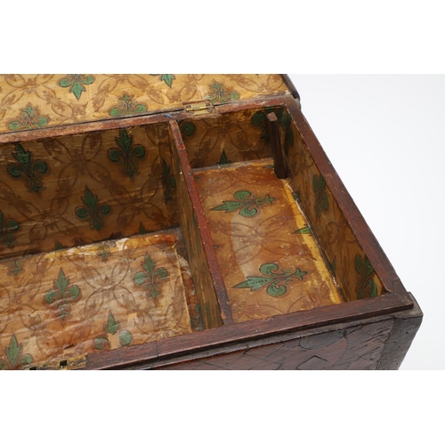 911 - AN ANTIQUE CONTINENTAL PARQUETRY BOX. the hinged lid enclosing a fleur de lys patterned paper lined ... 