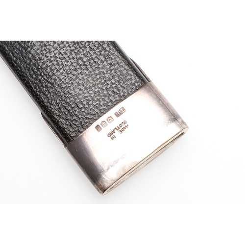 139 - A SCOTTISH SILVER MOUNTED SGIAN-DUBH. With a 9 cm Stainless Steel blade on a carved interlaced grip ... 