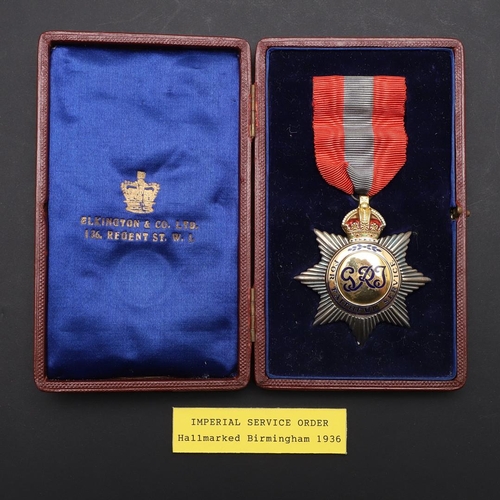 1008 - A GEORGE V IMPERIAL SERVICE ORDER. An Imperial Service Order on pin-backed red and blue ribbon, hall... 