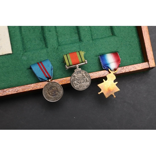 1025 - A COLLECTION OF MINIATURE MEDALS TO INCLUDE A MILITARY CROSS TRIO. A collection of miniature medals:... 