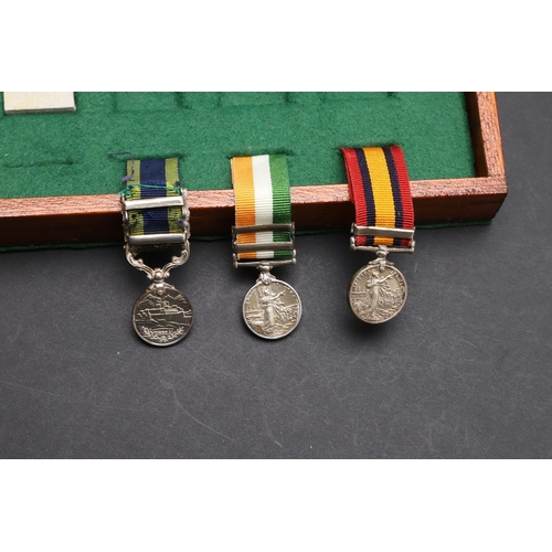 1025 - A COLLECTION OF MINIATURE MEDALS TO INCLUDE A MILITARY CROSS TRIO. A collection of miniature medals:... 