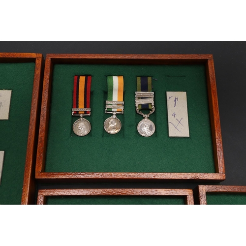 1025 - A COLLECTION OF MINIATURE MEDALS TO INCLUDE A MILITARY CROSS TRIO. A collection of miniature medals:... 