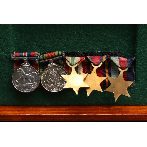 1025 - A COLLECTION OF MINIATURE MEDALS TO INCLUDE A MILITARY CROSS TRIO. A collection of miniature medals:... 