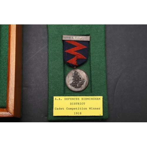 1028 - A FIRST WORLD WAR A.A. DEFENCES CADET MEDAL AND TWO OTHERS. An AA Defences medal engraved to the rev... 