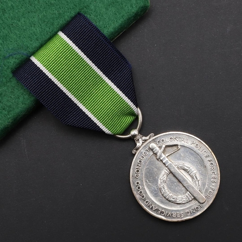 1033 - A GEORGE VI COLONIAL POLICE LONG SERVICE MEDAL. A George VI Colonial  Police Long Service Medal name... 