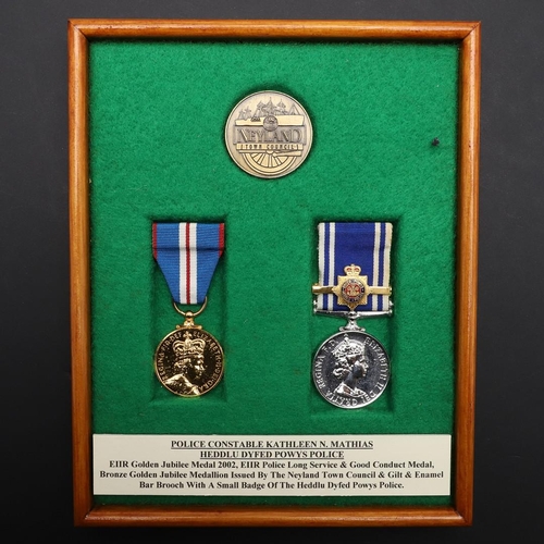 1035 - A PAIR OF MEDALS TO POLICE CONSTABLE KATHLEEN MATHIAS OF DYFED POWYS POLICE. A pair comprising Eliza... 