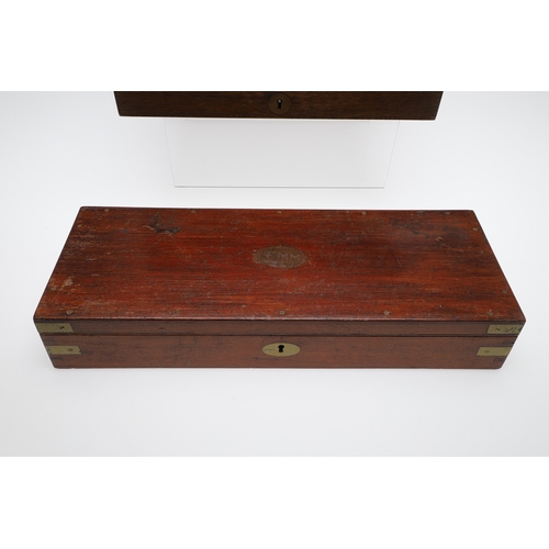 62 - TWO PISTOL BOXES, BOTH WITH VACANT INTERIORS. An oak pistol box, rectangular with a central brass di... 