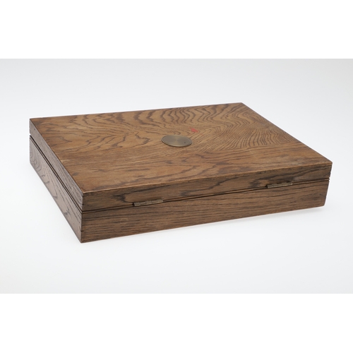 62 - TWO PISTOL BOXES, BOTH WITH VACANT INTERIORS. An oak pistol box, rectangular with a central brass di... 