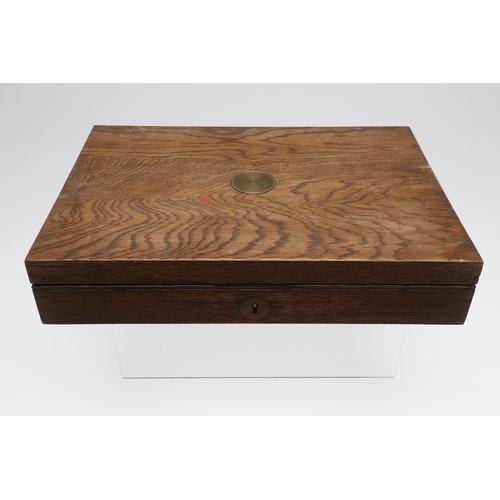 62 - TWO PISTOL BOXES, BOTH WITH VACANT INTERIORS. An oak pistol box, rectangular with a central brass di... 