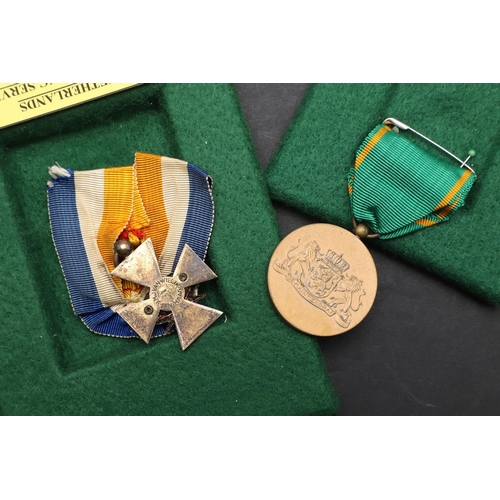 1166 - NETHERLANDS: FOUR MEDALS INCLUDING AN OFFICERS LONG SERVICE AWARD. Netherlands decoration for long, ... 