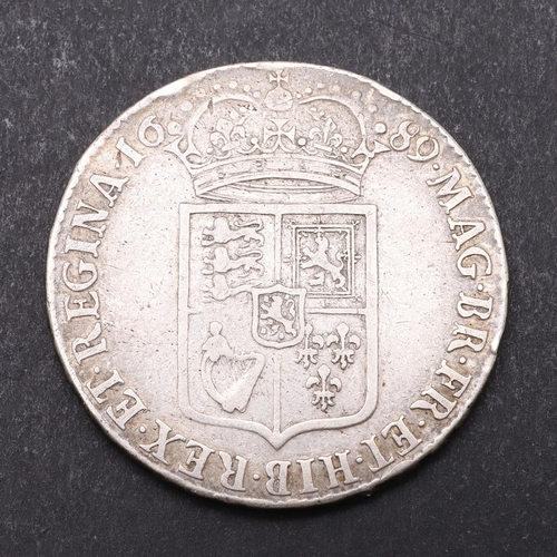 1500 - A WILLIAM AND MARY HALFCROWN, 1689. First busts r. Reverse with first crowned shield, dated 1689. Ri... 