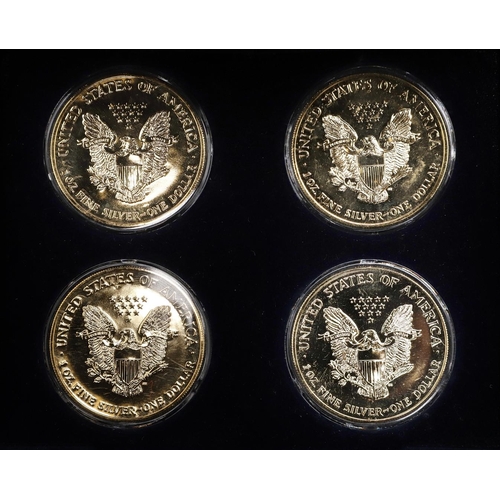 1643 - A WESTMINSTER MINT FOUR COIN GILT DOLLAR SET. A four coin set of gold plated 1 oz fine silver dollar... 