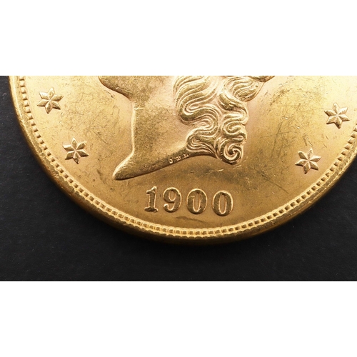 1923 - AN AMERICAN GOLD TWENTY DOLLAR COIN, 1900. A gold 20 dollar 'double eagle' coin. Liberty head l. ben... 