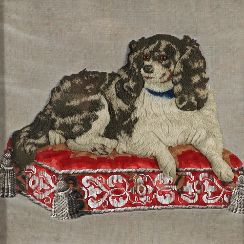 407 - A 19TH CENTURY RAISED WOOLWORK AND BEADED PICTURE. depicting a King Charles Spaniel lying upon a bea... 