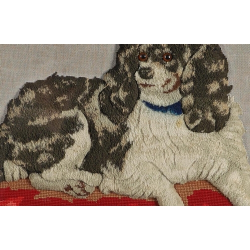 407 - A 19TH CENTURY RAISED WOOLWORK AND BEADED PICTURE. depicting a King Charles Spaniel lying upon a bea... 