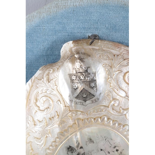 421 - A CARVED AND ENGRAVED MOTHER OF PEARL ARMORIAL SHELL PLAQUE. late 19th century, Crest of Layard, car... 