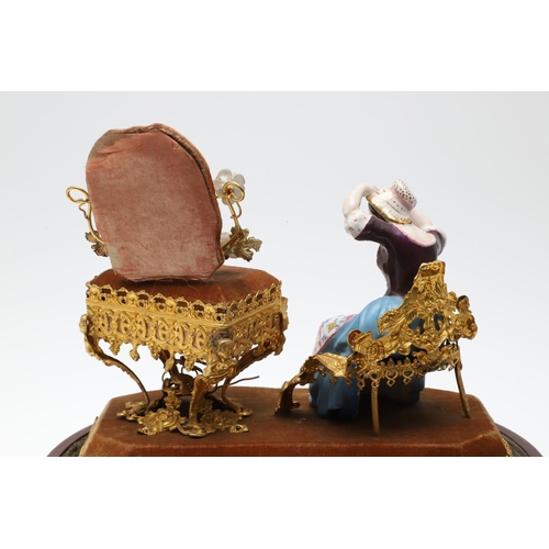 428 - AN UNUSUAL PORCELAIN FIGURE & GILT METAL DRESSING TABLE SEWING SET. 19th century, comprising of a se... 