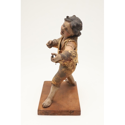 435 - AN ITALIAN CARVED SOFTWOOD FIGURE OF A BOY. possibly early 19th century, the semi-clothed figure mod... 