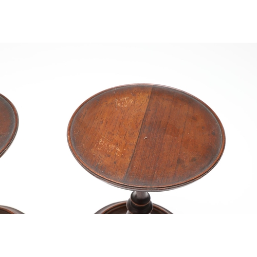 436 - A PAIR OF VICTORIAN ROSEWOOD CANDLE STANDS. with adjustable tops, turned stems and bases, height 21c... 