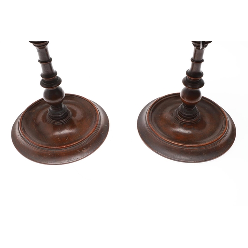 436 - A PAIR OF VICTORIAN ROSEWOOD CANDLE STANDS. with adjustable tops, turned stems and bases, height 21c... 