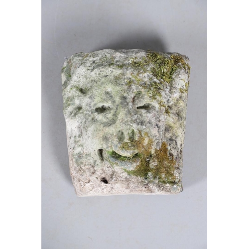 446 - A MEDIEVAL CARVED STONE CORBEL. depicting a Satyr, approx. 30cm high, 25cm wide x 24cm deep.