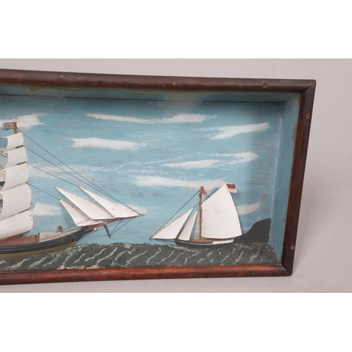 447 - A 19TH CENTURY SHIP DIORAMA. of a masted schooner and a smaller boat, with a painted background and ... 