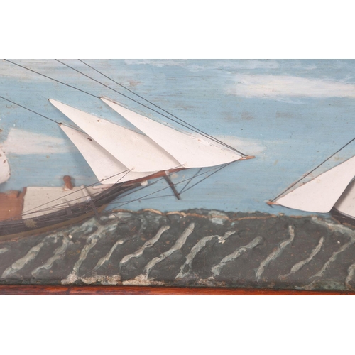 447 - A 19TH CENTURY SHIP DIORAMA. of a masted schooner and a smaller boat, with a painted background and ... 