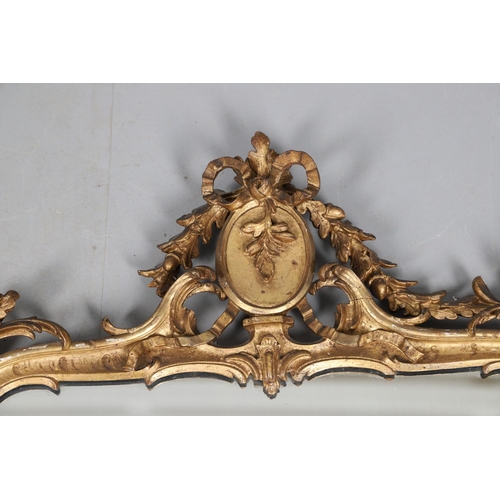 453 - A GEORGE III CARVED GILTWOOD AND GESSO WALL MIRROR. the elaborate cresting with ribbon tie surmounti... 