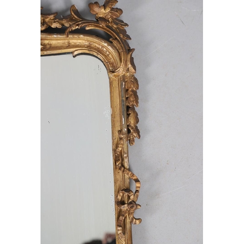 453 - A GEORGE III CARVED GILTWOOD AND GESSO WALL MIRROR. the elaborate cresting with ribbon tie surmounti... 