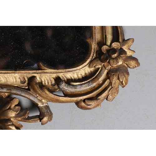 453 - A GEORGE III CARVED GILTWOOD AND GESSO WALL MIRROR. the elaborate cresting with ribbon tie surmounti... 