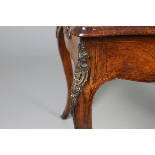 454 - A LOUIS XV STYLE BURR WALNUT AND MARQUETRY BUREAU PLAT. late 19th century, the shaped top with oval ... 