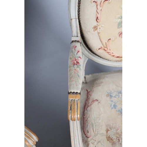 456 - A PAIR OF FRENCH PAINTED BEECH OPEN ARMCHAIRS. early 20th century, with brass studded floral tapestr... 