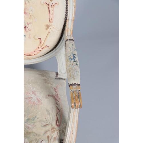 456 - A PAIR OF FRENCH PAINTED BEECH OPEN ARMCHAIRS. early 20th century, with brass studded floral tapestr... 