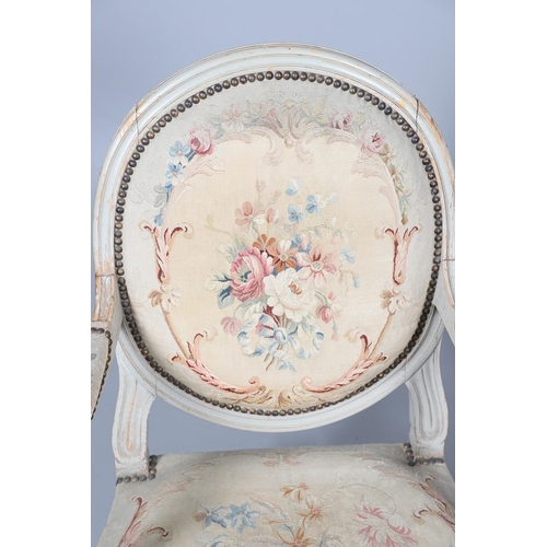 456 - A PAIR OF FRENCH PAINTED BEECH OPEN ARMCHAIRS. early 20th century, with brass studded floral tapestr... 