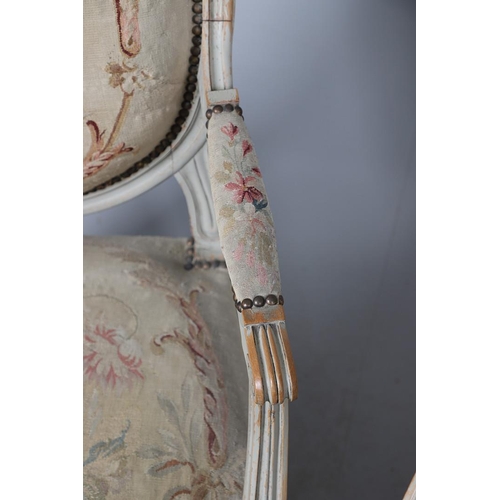 456 - A PAIR OF FRENCH PAINTED BEECH OPEN ARMCHAIRS. early 20th century, with brass studded floral tapestr... 