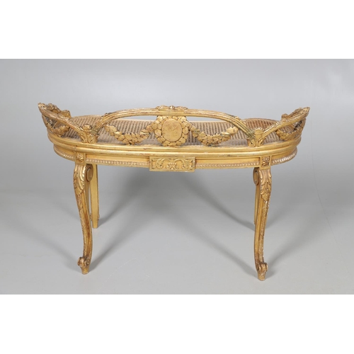 457 - A LATE 19TH CENTURY FRENCH GILTWOOD AND CANE WINDOW SEAT. the back with carved floral swags and bow ... 