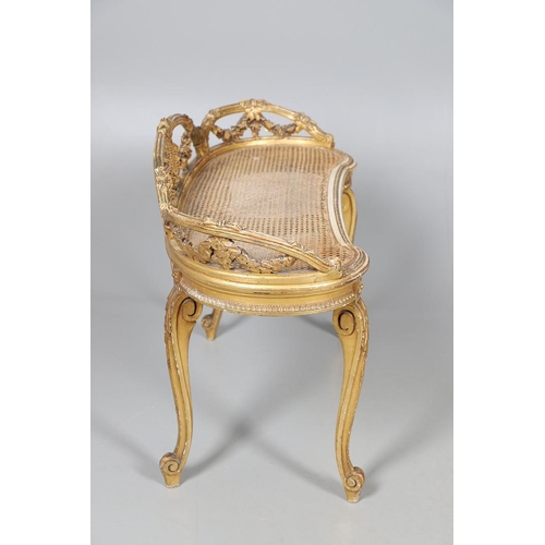 457 - A LATE 19TH CENTURY FRENCH GILTWOOD AND CANE WINDOW SEAT. the back with carved floral swags and bow ... 