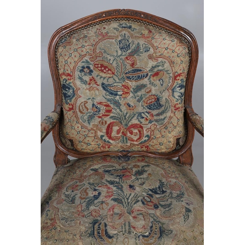 458 - AN EARLY 19TH CENTURY FRENCH WALNUT FAUTEUIL. the frame with scroll arms and serpentine seat, brass ... 