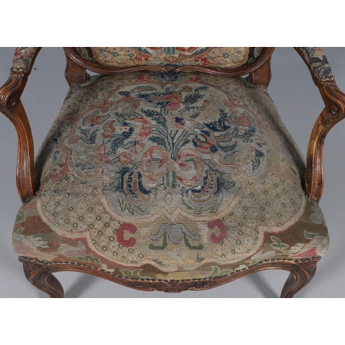 458 - AN EARLY 19TH CENTURY FRENCH WALNUT FAUTEUIL. the frame with scroll arms and serpentine seat, brass ... 