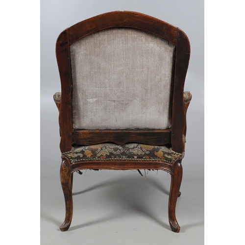 458 - AN EARLY 19TH CENTURY FRENCH WALNUT FAUTEUIL. the frame with scroll arms and serpentine seat, brass ... 