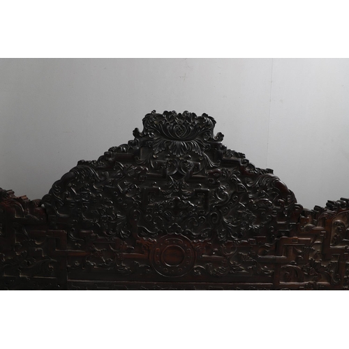 463 - AN EARLY 20TH CENTURY CHINESE CARVED HARDWOOD HEADBOARD. predominantly rosewood and other hardwood, ... 