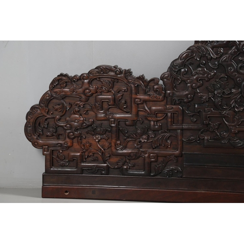 463 - AN EARLY 20TH CENTURY CHINESE CARVED HARDWOOD HEADBOARD. predominantly rosewood and other hardwood, ... 